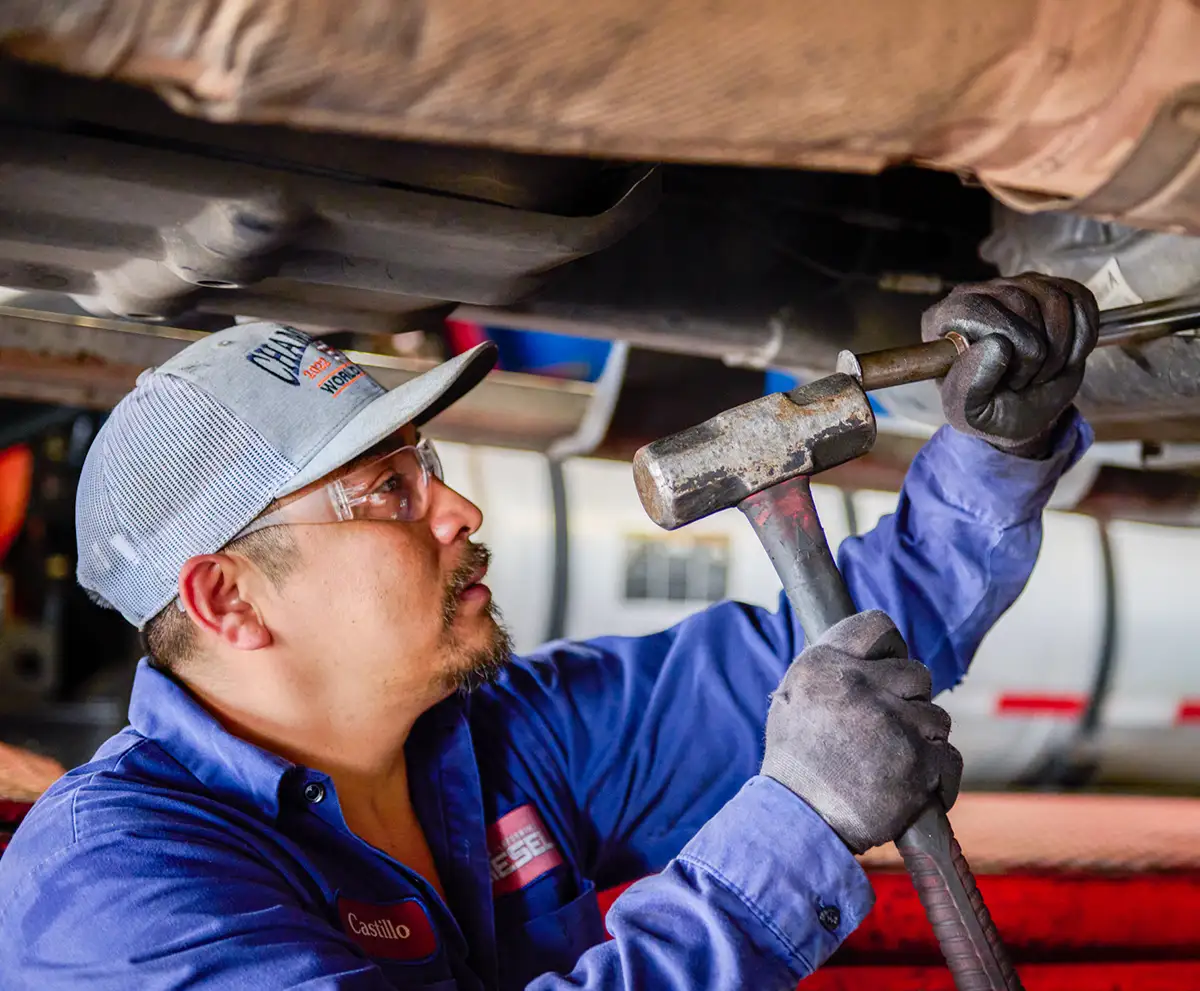 Mechanic performing repairs at Houston Performance Diesel